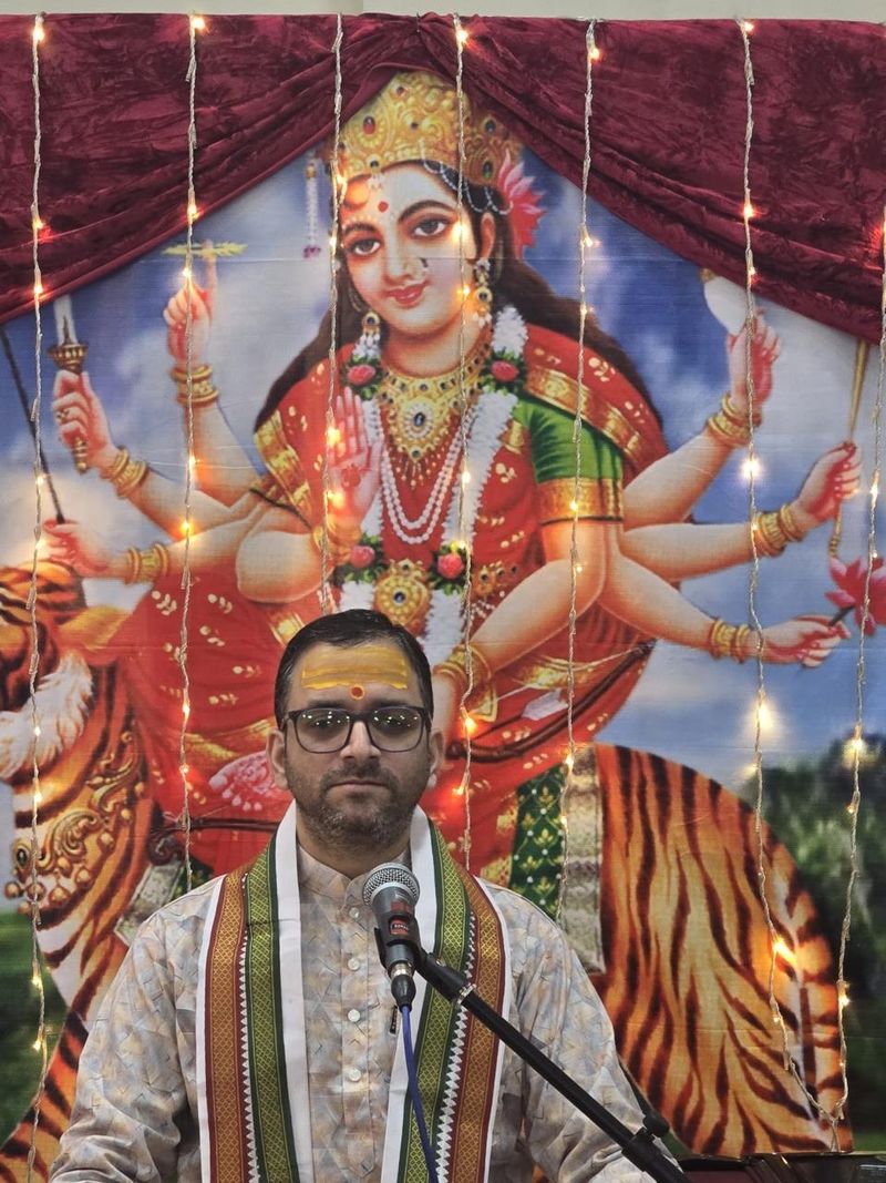 Pandit performing a Durga puja ceremony for a family in the UAE